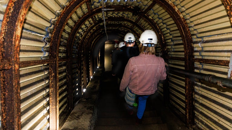 Image of a guided tour descending the stairs into Fan Bay Deep Shelter, The White Cliffs of Dover, Kent